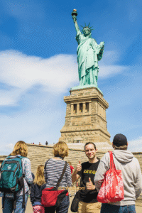 Zinner Digital Nomad Is Working In New York By The Statue Of Liberty